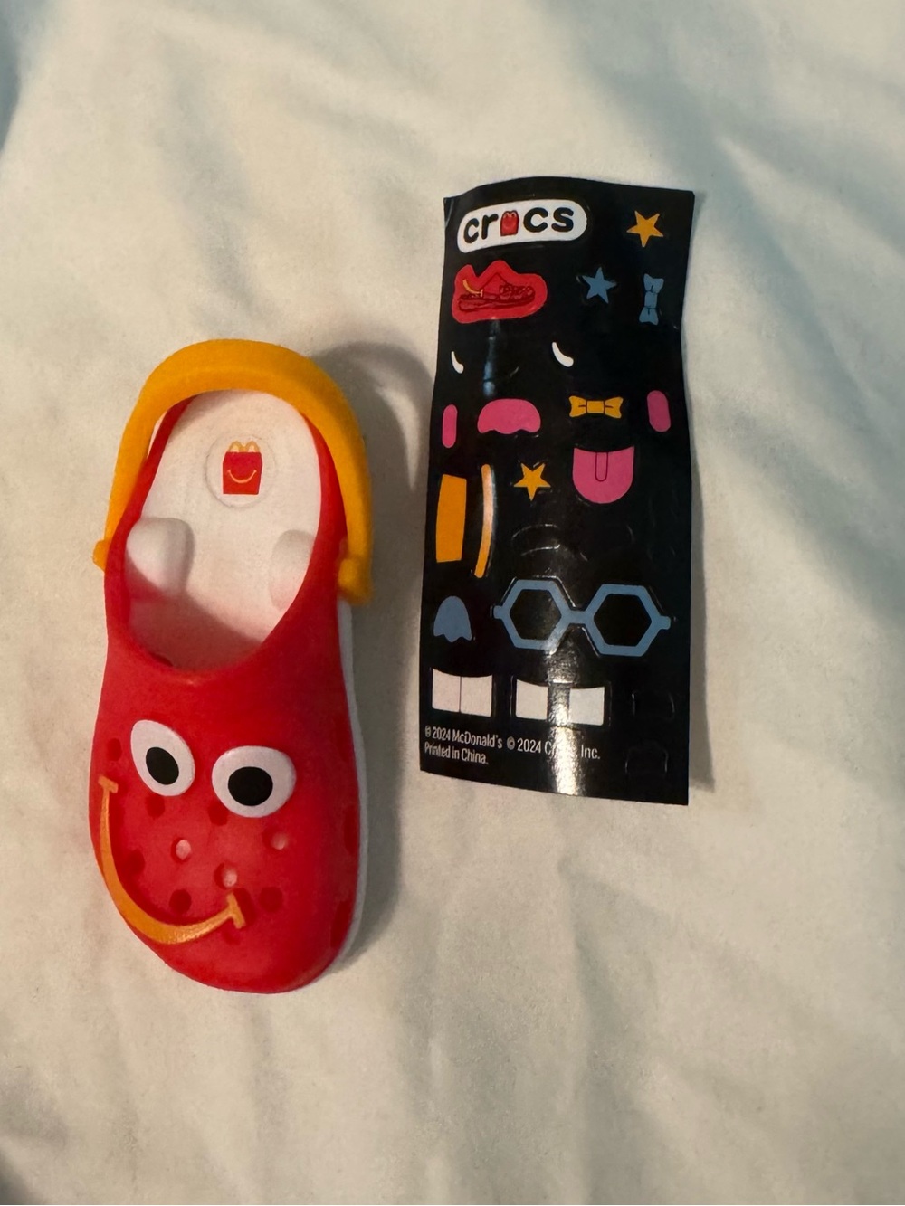 McDonald's x Crocs Happy Meal toy and sticker sheet